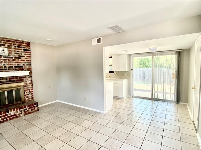 8502 Woodstone Dr, Austin, TX 78757 - unfurnished living room with light tile patterned floors, baseboards, and a brick fireplace