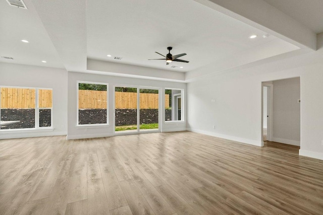 8800 Bar K Ranch Rd, Lago Vista, TX 78645 - unfurnished living room with a tray ceiling, recessed lighting, a ceiling fan, and wood finished floors