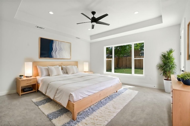 8800 Bar K Ranch Rd, Lago Vista, TX 78645 - bedroom featuring a raised ceiling, light colored carpet, baseboards, recessed lighting, and ceiling fan