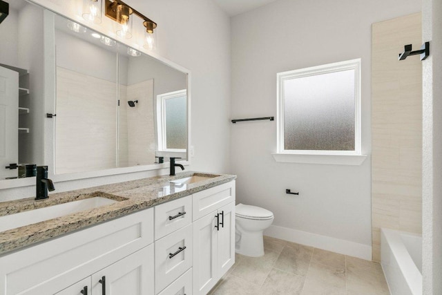 8800 Bar K Ranch Rd, Lago Vista, TX 78645 - bathroom with a tile shower, toilet, double vanity, and baseboards
