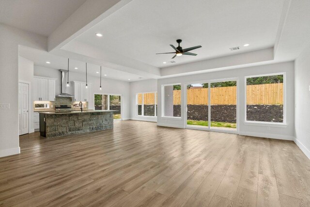 8800 Bar K Ranch Rd, Lago Vista, TX 78645 - unfurnished living room with wood finished floors, recessed lighting, ceiling fan, a sink, and baseboards
