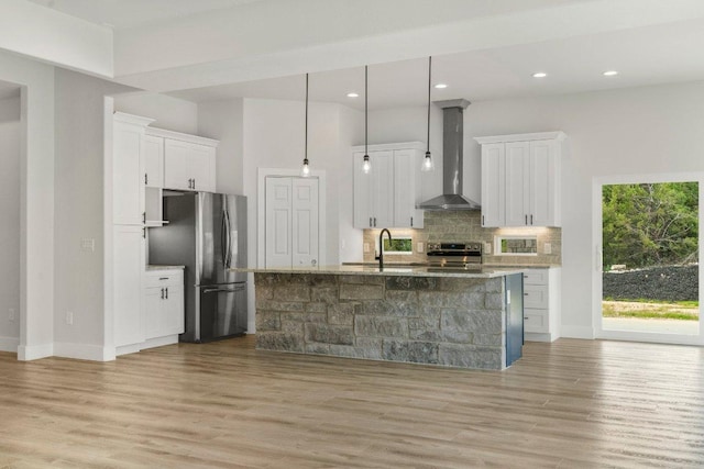 8800 Bar K Ranch Rd, Lago Vista, TX 78645 - kitchen featuring stainless steel appliances, wall chimney range hood, decorative backsplash, white cabinets, and recessed lighting