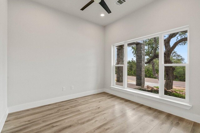 8800 Bar K Ranch Rd, Lago Vista, TX 78645 - unfurnished room with a ceiling fan, light wood-style floors, recessed lighting, and baseboards