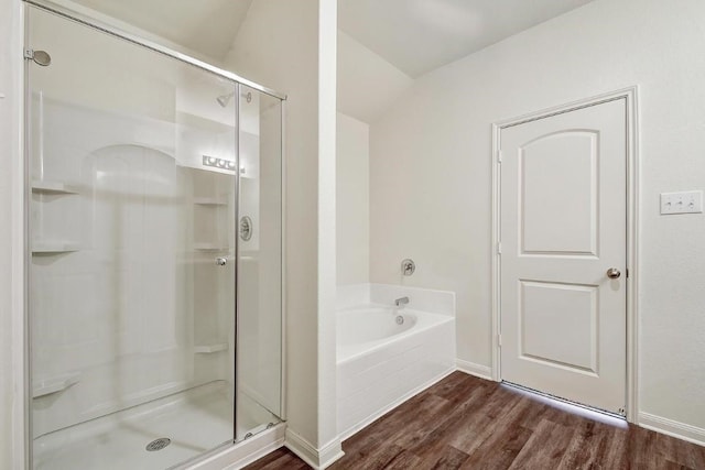 1174 Amy Dr, Kyle, TX 78640 - full bathroom featuring wood finished floors, a stall shower, a garden tub, baseboards, and lofted ceiling