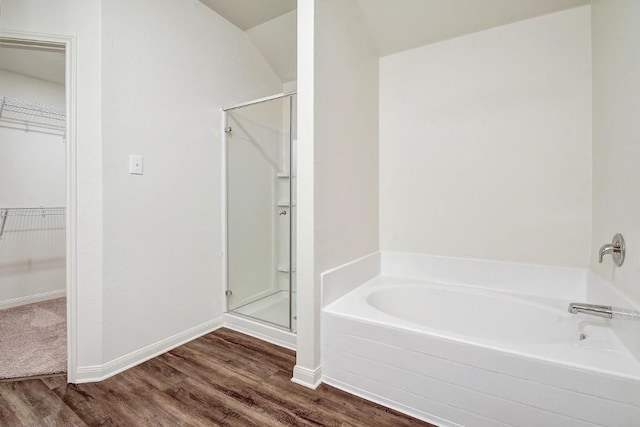 1174 Amy Dr, Kyle, TX 78640 - full bath featuring a stall shower, a spacious closet, wood finished floors, and a garden tub