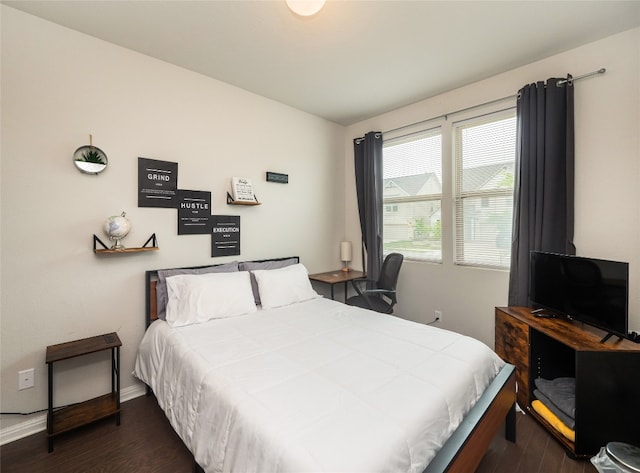 111 Lyrebird Ln, Hutto, TX 78634 - bedroom featuring dark wood-style floors and baseboards