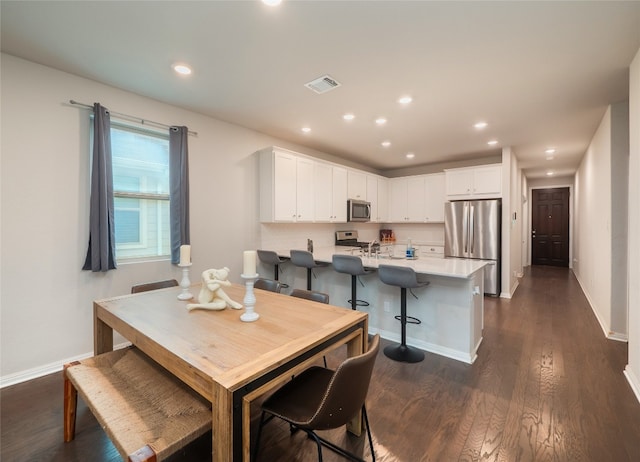 111 Lyrebird Ln, Hutto, TX 78634 - dining area with dark wood-style floors, baseboards, and recessed lighting