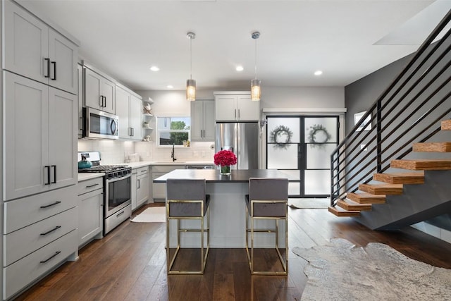 4423 Jinx Ave Unit 2, Austin, TX 78745 - kitchen featuring appliances with stainless steel finishes, decorative backsplash, open shelves, dark wood finished floors, and a sink