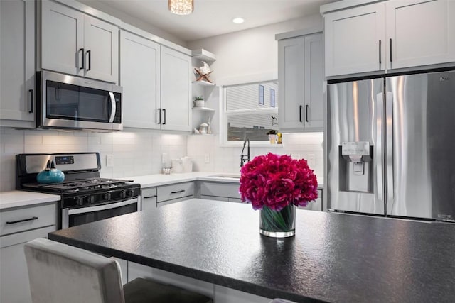 4423 Jinx Ave Unit 2, Austin, TX 78745 - kitchen with stainless steel appliances, open shelves, backsplash, recessed lighting, and a breakfast bar area