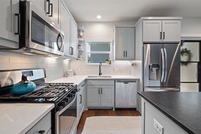 4423 Jinx Ave Unit 2, Austin, TX 78745 - kitchen with appliances with stainless steel finishes, dark wood finished floors, decorative backsplash, recessed lighting, and open shelves