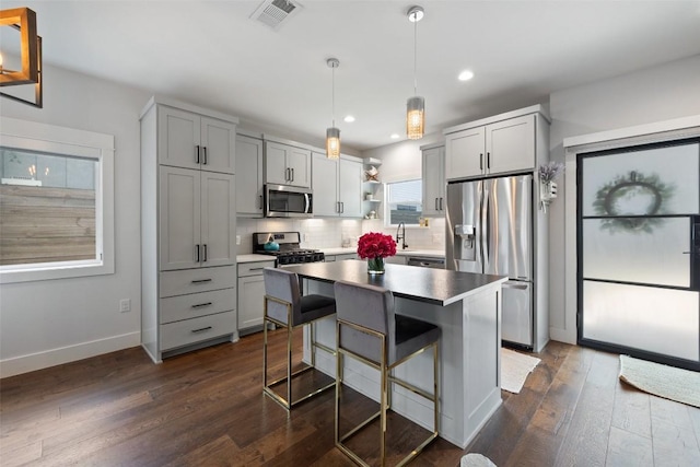 4423 Jinx Ave Unit 2, Austin, TX 78745 - kitchen featuring stainless steel appliances, open shelves, dark wood-type flooring, gray cabinets, and recessed lighting