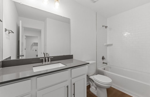 full bathroom with wood finished floors, toilet, vanity, and shower / bathtub combination