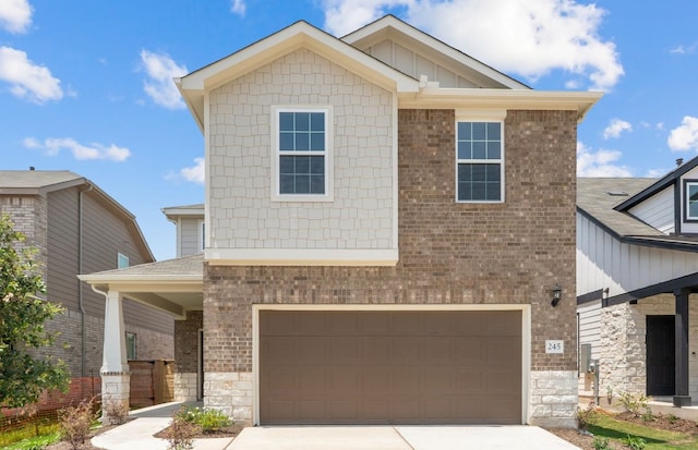 view of front of home featuring a garage, concrete driveway, brick siding, and stone siding