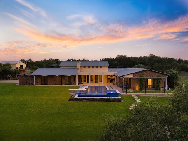 9208 Madrone Ranch Trl, Austin, TX 78738 - rear view of house with a lawn, a hot tub, an outdoor pool, a patio, and metal roof