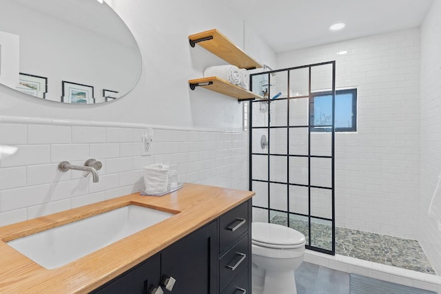 9208 Madrone Ranch Trl, Austin, TX 78738 - bathroom featuring toilet, a tile shower, vanity, tile walls, and recessed lighting