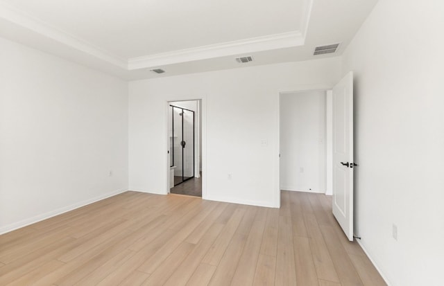 117 Crossbar St, Georgetown, TX 78633 - empty room featuring a tray ceiling, light wood-style floors, crown molding, and baseboards