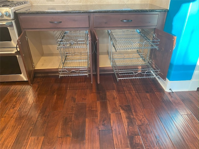 kitchen view of wood finished floors and stainless steel range with gas cooktop