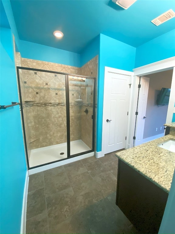 full bath with a shower stall and vanity