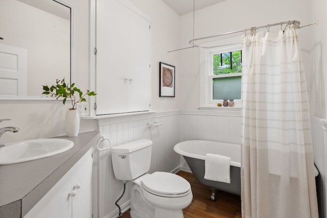 512 E 49th St, Austin, TX 78751 - bathroom featuring a freestanding bath, vanity, wood finished floors, and wainscoting