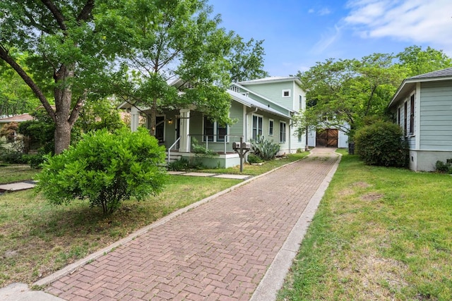 512 E 49th St, Austin, TX 78751 - view of front of home with covered porch, a front yard, and decorative driveway