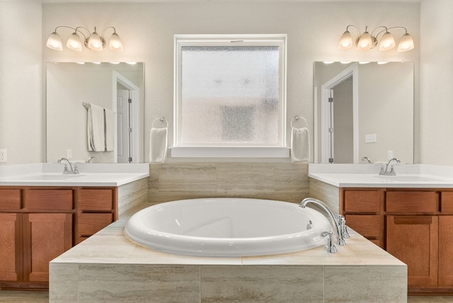 full bath with two vanities and a garden tub