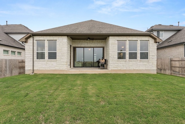 rear view of property with a ceiling fan, stone siding, a patio, and a shingled roof