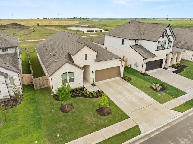 view of front of property featuring concrete driveway, a shingled roof, and stone siding