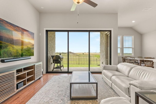 living area featuring wood finished floors, ceiling fan, recessed lighting, and lofted ceiling