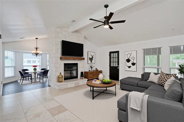 4703 Quicksilver Blvd, Austin, TX 78744 - living area featuring light tile patterned floors, ceiling fan, a chandelier, and a large fireplace