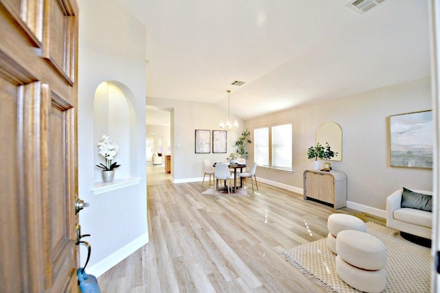 11120 Old Quarry Rd, Austin, TX 78717 - entrance foyer with a chandelier, lofted ceiling, light wood finished floors, arched walkways, and baseboards
