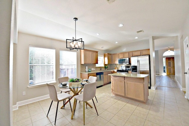 11120 Old Quarry Rd, Austin, TX 78717 - kitchen with stainless steel appliances, vaulted ceiling, a center island, light tile patterned floors, and baseboards