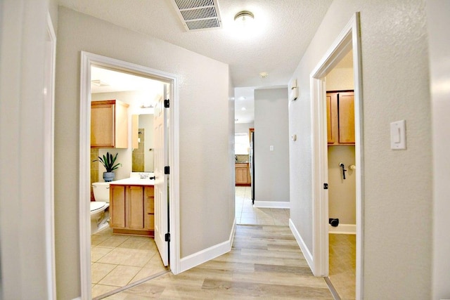 11120 Old Quarry Rd, Austin, TX 78717 - corridor with light tile patterned flooring and a textured ceiling
