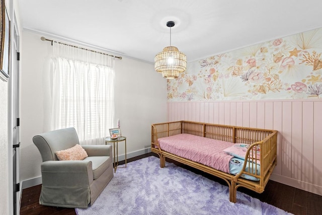 bedroom featuring wainscoting, ornamental molding, and wallpapered walls