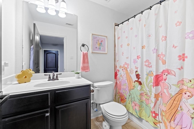 bathroom with toilet, vanity, tile patterned flooring, and a shower with shower curtain