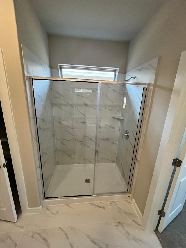 264 Little Green Trl, Jarrell, TX 76537 - full bathroom featuring a marble finish shower and marble look tile flooring