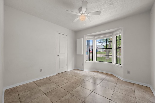 1605 Quail Run Rd, Pflugerville, TX 78660 - unfurnished room with light tile patterned flooring, a ceiling fan, a textured ceiling, and baseboards