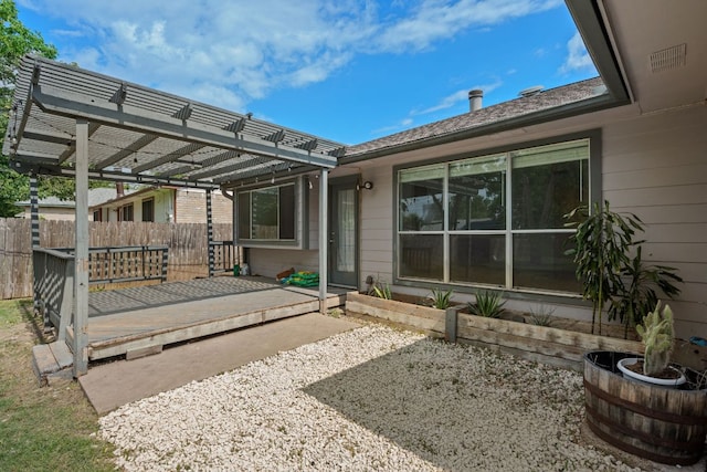 rear view of house featuring a pergola, fence, and a patio area