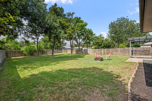 view of yard featuring an outdoor fire pit