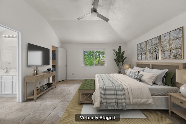bedroom with lofted ceiling, light tile patterned flooring, ensuite bath, a sink, and ceiling fan