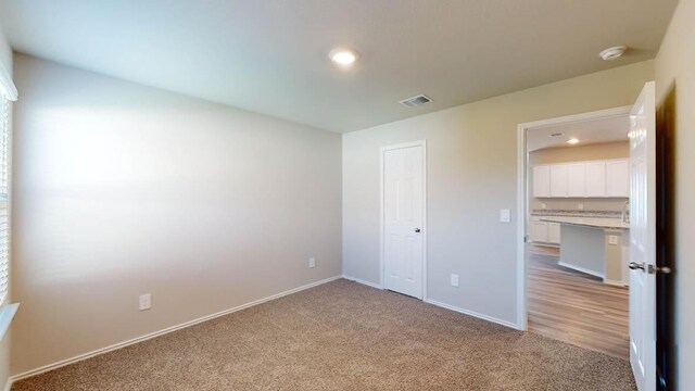 2402 Bee Creek Dr, Copperas Cove, TX 76522 - unfurnished bedroom featuring light colored carpet, baseboards, recessed lighting, and a closet