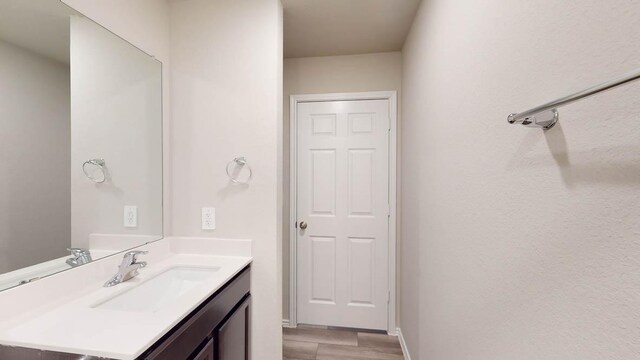 2402 Bee Creek Dr, Copperas Cove, TX 76522 - bathroom with vanity, wood finished floors, and baseboards