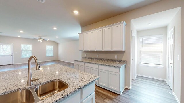 2402 Bee Creek Dr, Copperas Cove, TX 76522 - kitchen featuring a sink, light wood finished floors, white cabinetry, ceiling fan, and recessed lighting
