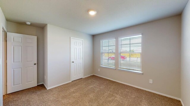 2402 Bee Creek Dr, Copperas Cove, TX 76522 - unfurnished bedroom featuring light carpet, baseboards, and a closet