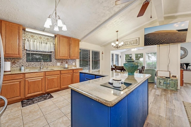 kitchen with a chandelier, black electric stovetop, a sink, and a ceiling fan