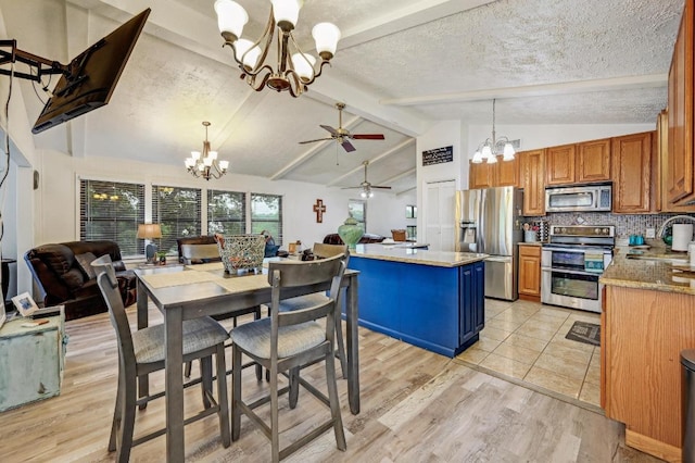 dining space featuring a chandelier, ceiling fan, light wood-style floors, and a textured ceiling