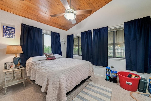 carpeted bedroom featuring wood ceiling, vaulted ceiling, a ceiling fan, and baseboards