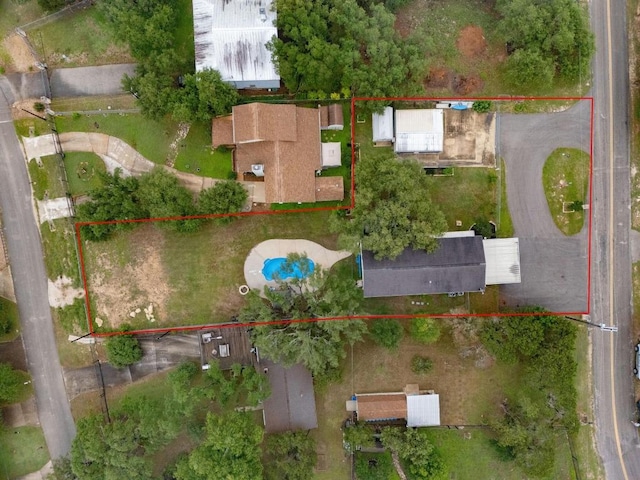 aerial view of property and surrounding area featuring property parcel outlined and a pool