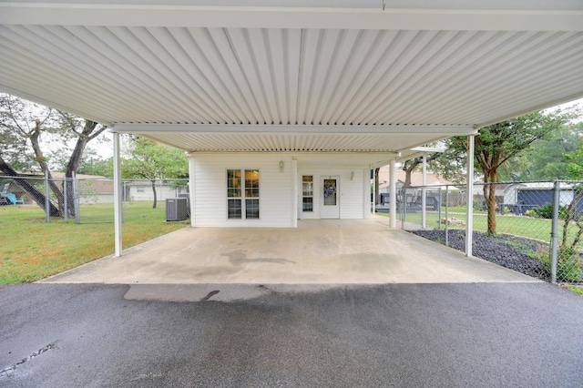 view of patio with central air condition unit and a carport