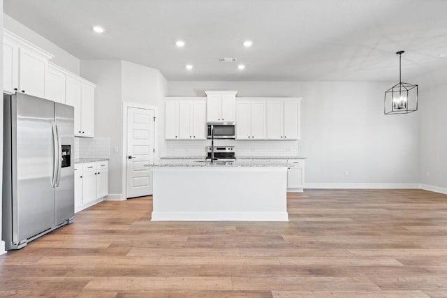 9321 Gladsome Path, Manor, TX 78653 - kitchen featuring stainless steel appliances, backsplash, white cabinets, and recessed lighting