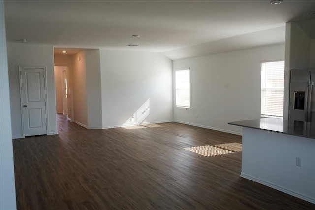 5605 Bellissima Way, Round Rock, TX 78665 - unfurnished living room with dark wood finished floors, baseboards, and lofted ceiling